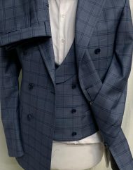 Light blue 3 piece plaid super 150 Cerruti double breasted wool suit with double breasted vest, double vents on suit,wide peak lapel double hand stitched, slanted ticket pocket, soft Neapolitan structured shoulders, flat front pant. Available in sizes 36-54 regular and long including custom bespoke. If the cut, style, fit and price of this suit does not exceed your expectations, return it for a full refund.