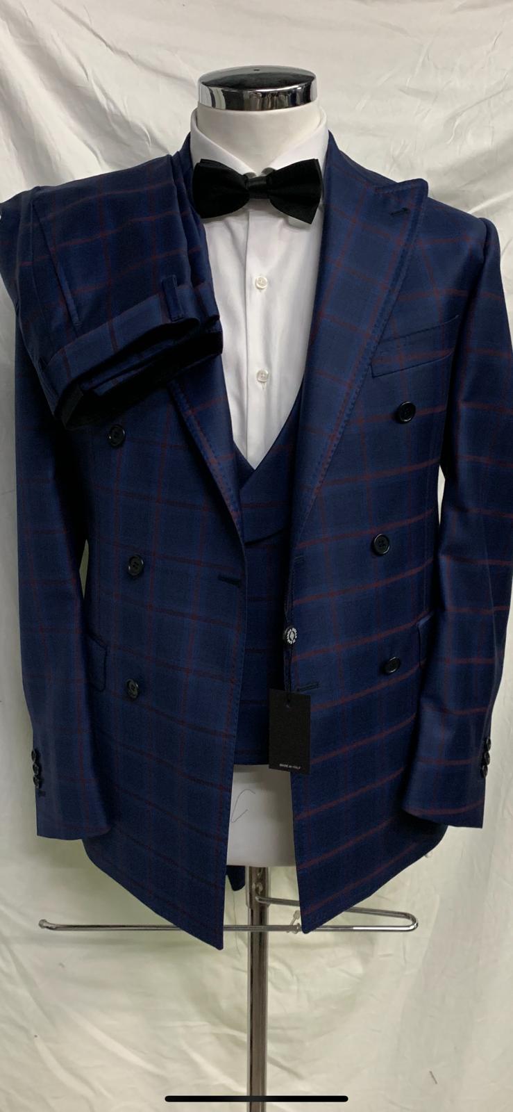 Navy/red 3 piece windowpane super 150 Cerruti wool suit with double breasted vest, double vents on suit,wide peak lapel double hand stitched, slanted ticket pocket, soft Neapolitan structured shoulders, flat front pant. Available in sizes 36-54 regular and long including custom bespoke.