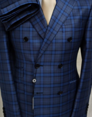Navy/grey plaid super 180 Tombojlini double breasted wool suit with wide peak lapel, hand stitched, ticket pocket, 10 inch double vents, fitted jacket and pant. Available in size 36-50 regular or long. Made in Italy.