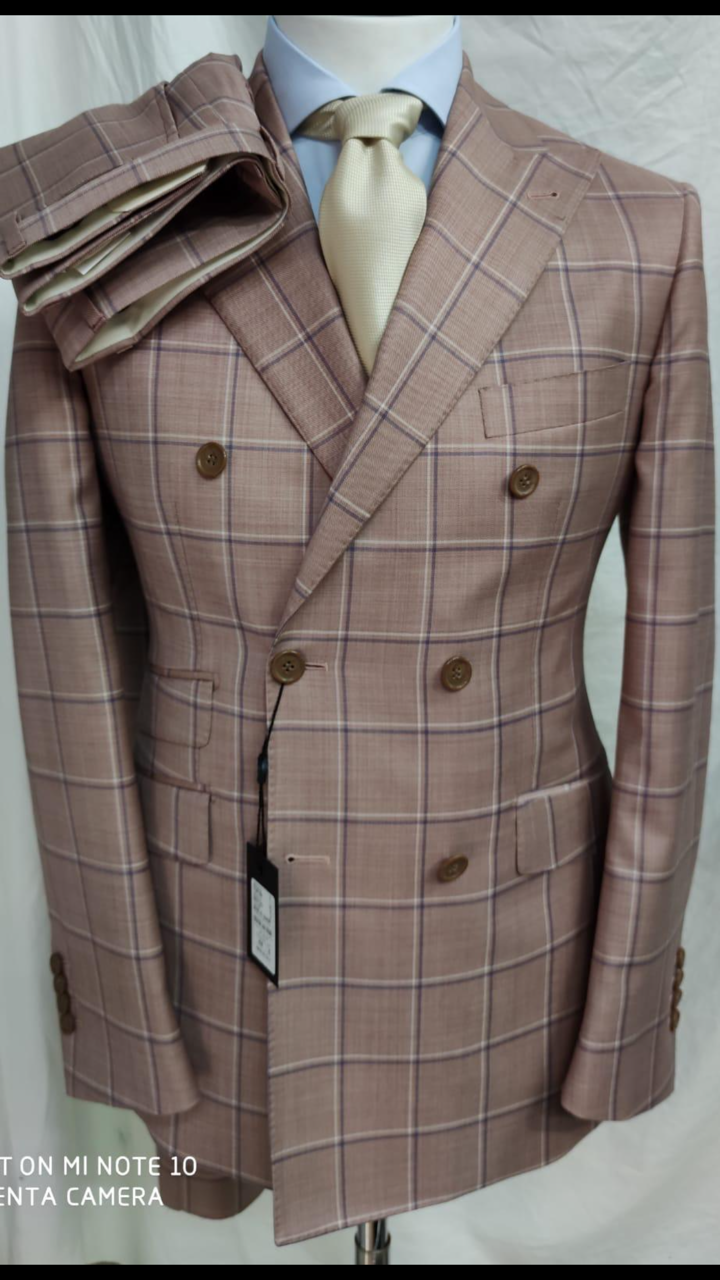 Rose windowpane super 180 Tombojlini double breasted wool suit with wide peak lapel, hand stitched, ticket pocket, 10 inch double vents, fitted jacket and pant. Available in size 36-50 regular or long. Made in Italy.