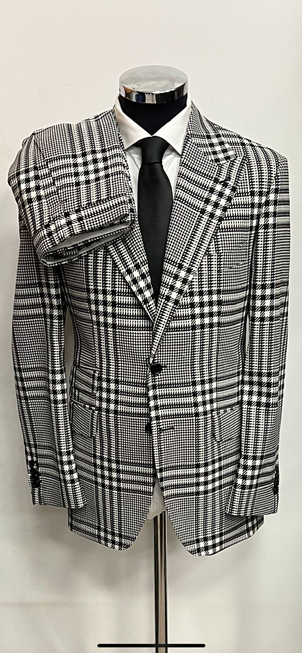 Black/white luxury cashmere plaid Ariston wool suit. Wide 5 inch peak lapel double stitched. Ticket pocket, double vent jacket, open button sleeves. Flat front pants. Limited quantity made in size 40-60 R/L